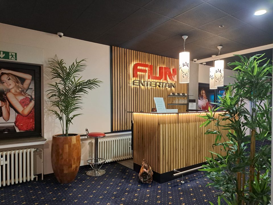 Empfangsbereich der Spielhalle Voerde mit Tresen und Fun-Entertain-Leuchtschrift